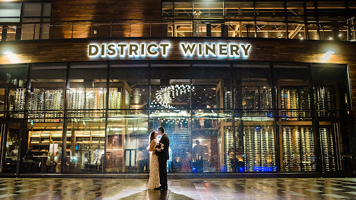 Nighttime shot of couple outside of District Winery.